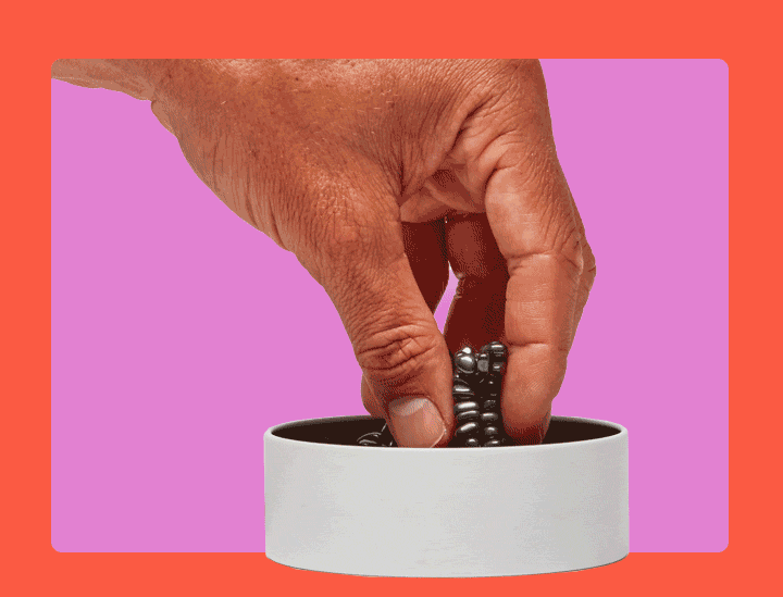a hand holding a cup